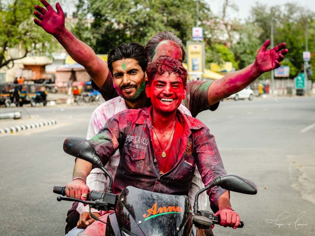 Men celebrating the Holi Festival, India on a motorbike